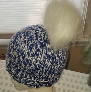 Hand knit beanie with poof